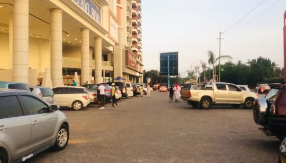 People in parking lot of Palm Village Mall in Dar Es Salaam, Tanzania